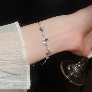 Detail of adjustable silver heart bracelet with cubic zirconia and sliding clasp closure