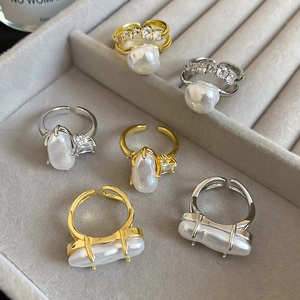 Detailed view of irregular Baroque pearl rings with zircon in gold and silver finish