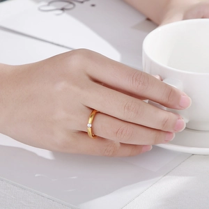 Close-up of minimalist gold zircon ring worn on finger with elegant lifestyle background
