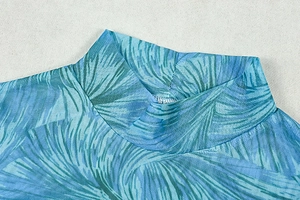 Close-up of semi-sheer mesh high collar with blue and green floral print detail