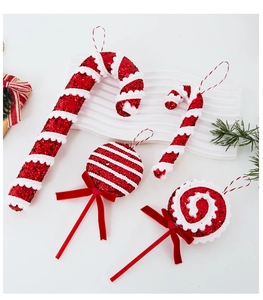 Close-up of festive red and white candy cane ornaments with glitter and velvet bows