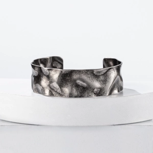 Polished wide hammered cuff bracelet in oxidised steel with water ripple texture