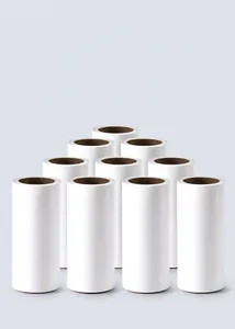 Macro view of 10-pack white lint roller refills stacked on a light blue gradient background