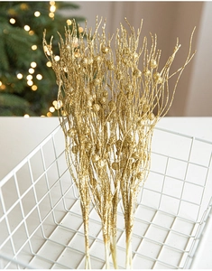 Detailed view of golden glitter branches and berries for Christmas floral decorations