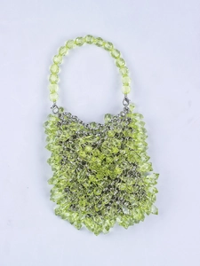 Close-up of lime green beaded handbag with faceted acrylic droplets and metal clasp