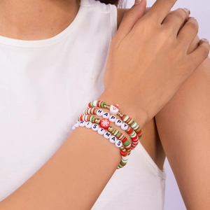 Detail of Christmas beaded bracelet set featuring Santa charms and colorful clay beads