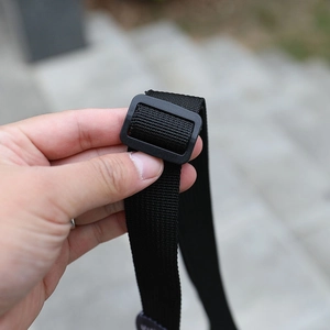 Detail of adjustable black nylon strap with durable plastic buckle for kids backpack
