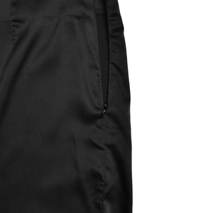 Detail view of the side invisible zipper on a black ruched slim fit mermaid skirt