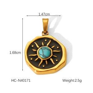 Detail of a gold-plated sunburst pendant with turquoise stone and dimensions 1.47x1.68cm