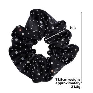 Macro shot of 11.5cm black satin hair scrunchie with sparkling rhinestones and dimensions