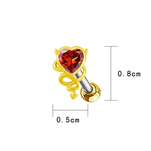 Macro shot of gold devil heart ear stud with red gemstone and precise dimensions