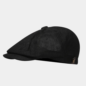 Detail of black newsboy cap with breathable mesh fabric and brown leather side tag