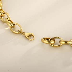 Detailed close-up of golden stainless steel chunky chain link with lobster clasp