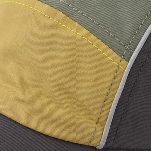 Macro view of durable multi-color cotton canvas cap stitching with reflective detail