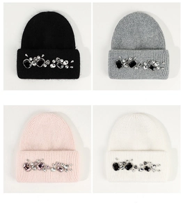 Detail of rhinestone embellishments on knitted beanies in black, grey, pink and white