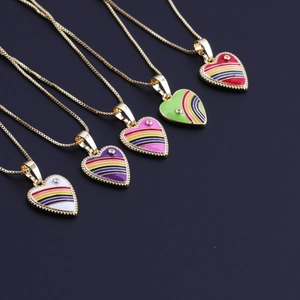 Close-up of five colorful enamel rainbow heart pendants on gold-plated box chains