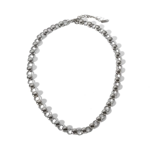 Detailed close-up of a stainless steel bead and ring chain necklace on a white background