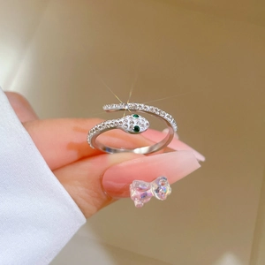 Silver snake wrap ring in stainless steel with crystal pavé and green stone eyes