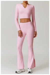 Detail of light pink yoga set featuring V-neck long sleeve top and flared split-hem pants