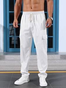 Detail of white men's cargo pants featuring drawstring waist and large side pockets