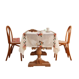 Christmas table runner with festive red and green embroidery and horse motifs on beige base