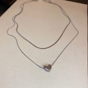 Double-layered silver choker necklace with snake chain and heart pendant accessory