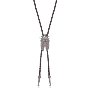 Close-up of vintage silver cicada pendant on brown braided leather bolo tie necklace