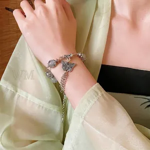 Bracelet papillon élégant avec perles de marbre gris et glands argentés pour femmes
