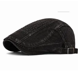 Detail of black denim flat cap featuring diamond quilt texture and adjustable metal buckle