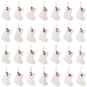 Set of 28 white knit Christmas stockings with red embroidered A-Z letters and holiday patterns