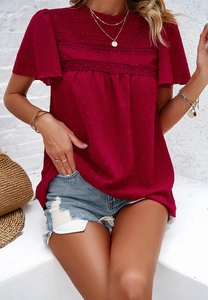 Detail of burgundy lace short sleeve top with polka dot texture and pleated ruffles