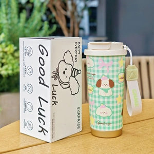 Close-up of insulated stainless steel dog cup with green checkered pattern and box