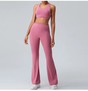 Detailed front view of high-waist flared yoga pants and crossover sports bra set in rose pink
