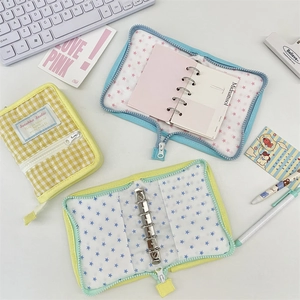 Detailed view of mini fabric binder planners with zipper closure and 6-ring metal binder