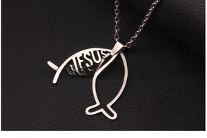 Macro shot of silver Jesus Ichthys fish pendant with engraved text on black leather