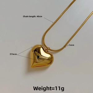 Detailed view of golden heart pendant on snake chain with 40cm length and 23mm size