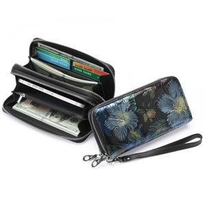 Black leather long wallet with embossed floral design and double zipper compartments