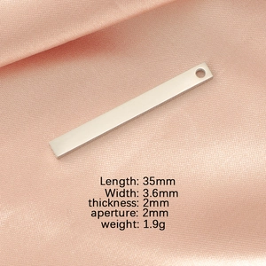 Detailed specs of mirror-polished rectangular stainless steel pendant on pink silk