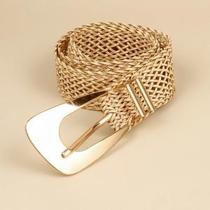 Detail of hand-woven straw belt with a polished gold geometric triangle buckle