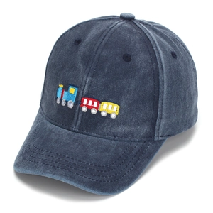 Close-up of high-quality embroidery featuring a colorful train on a navy cotton baseball cap