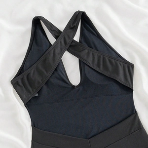Sleek black backless swimsuit with crisscross rib texture straps on silk background