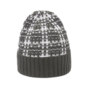 Detailed view of the thick knit beanie with black and white plaid texture and grey ribbed cuff