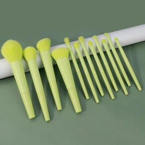 Macro detail of a 13-piece neon makeup brush set with synthetic bristles on white props