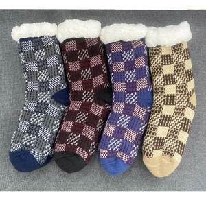 Detailed view of non-slip sole and thick fleece lining on checkered thermal slipper socks