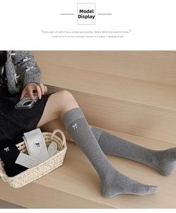 Detail of knee high cotton socks with cute bow embroidery on the side in three colors