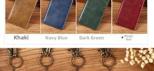 Detail view of vintage leather card holders in four colors with antique bronze keychains