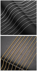 Close-up detail of silver and gold snake bone chains on black leather background