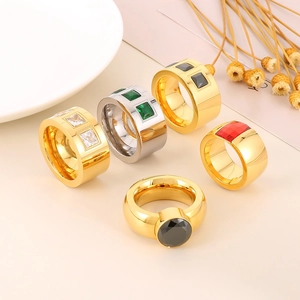 Luxe titanium steel rings set with colorful geometric zircons on a ceramic display