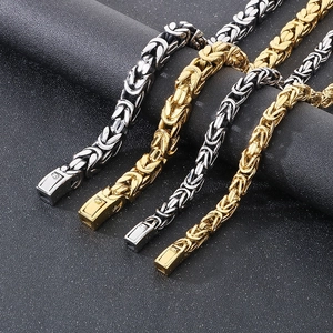 Detailed macro view of gold and silver Byzantine chain bracelets with box clasps