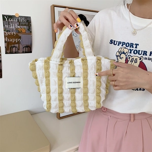 Close-up of yellow striped bubble fabric handbag with Love Sozakka label detail